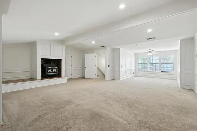a bathroom with a sink double vanity granite tub and a mirror