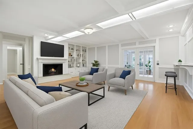 a view of an empty room with wooden floor and cabinet