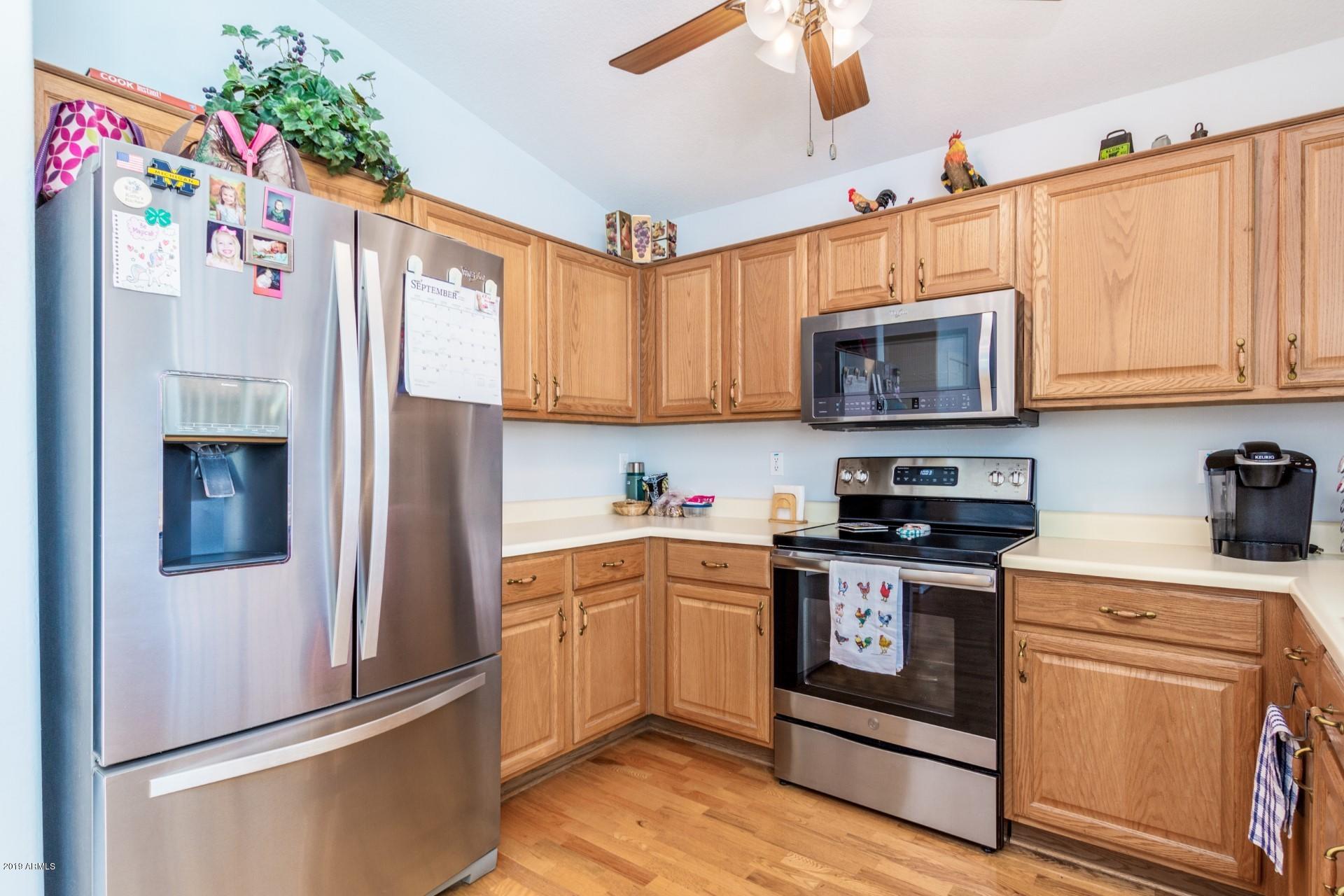 15033 West Calavar Road Surprise, AZ 85379 - Photo 8 of 21 a kitchen with stainless steel appliances granite countertop a refrigerator stove microwave and sink