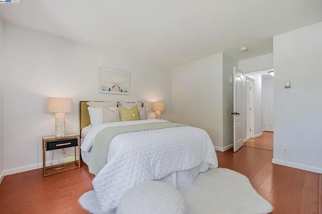 a bedroom with a bed and a lamp