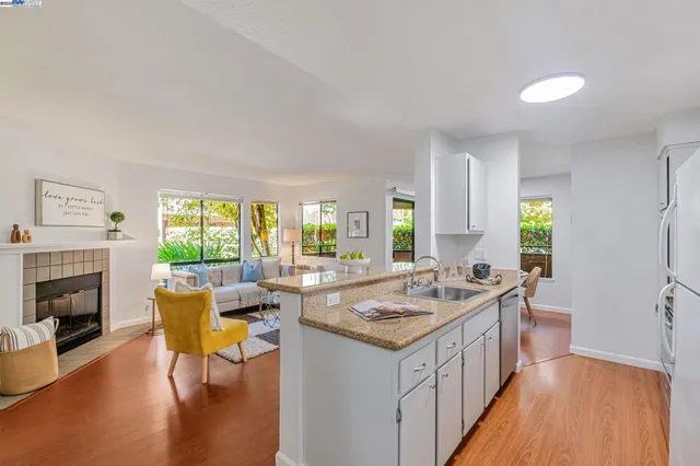 a open kitchen with granite countertop a sink and a stove