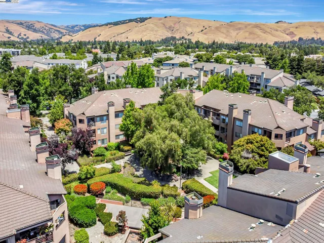 an aerial view of a houses with a swimming pool