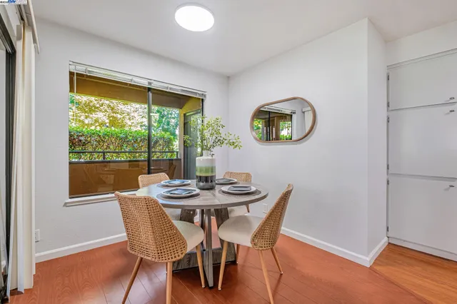 a view of a dining room with furniture and window