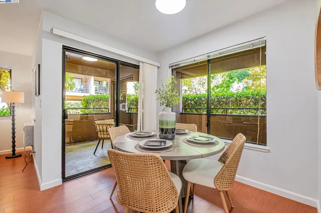 a dining room with furniture window and wooden floor