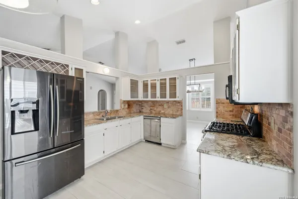 a kitchen with a refrigerator and a sink