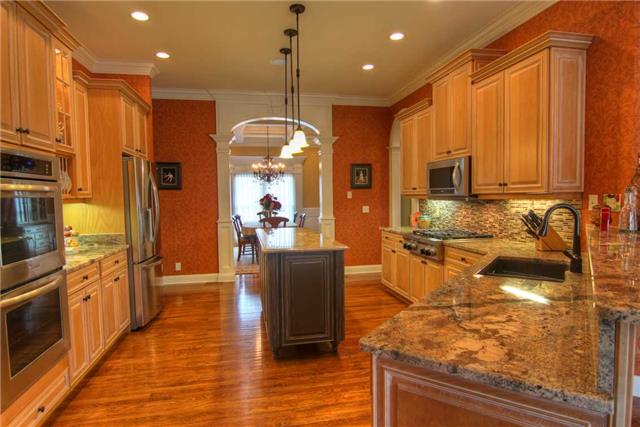 2305 Armstrong Valley Road Murfreesboro, TN 37128 - Photo 9 of 27 a kitchen with stainless steel appliances granite countertop a sink counter space and wooden floor