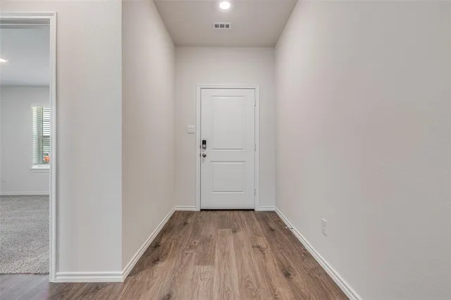 a view of a room with wooden floor