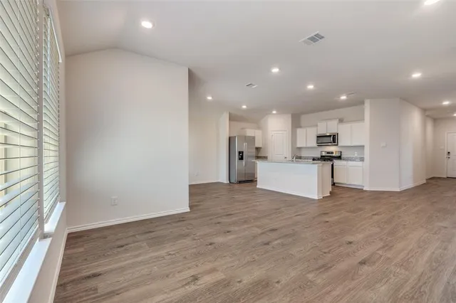 a kitchen with stainless steel appliances granite countertop a stove and a refrigerator