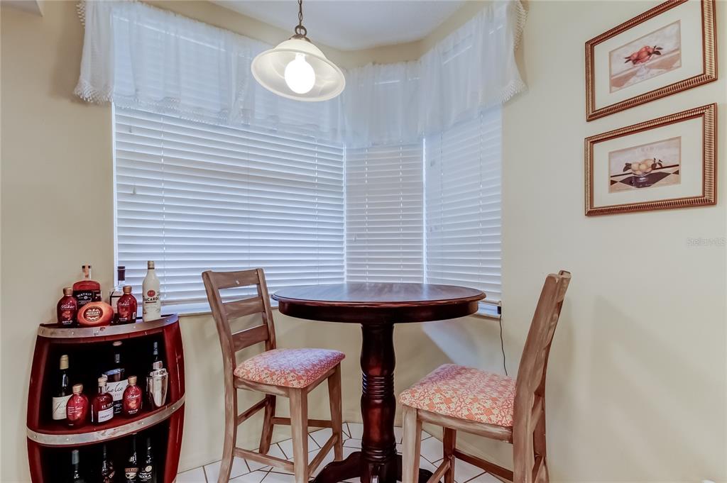 6205 Shoreline Drive, Unit 1304 Seminole, FL 33708 - Photo 13 of 57 a view of a dining room with furniture and wooden floor