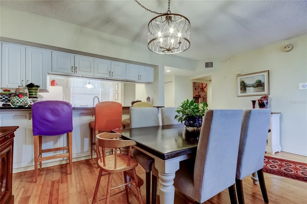 6205 Shoreline Drive, Unit 1304 Seminole, FL 33708 - Photo 17 of 57 a view of a dining room with furniture and wooden floor