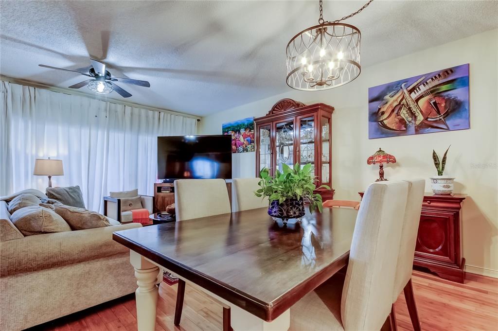 6205 Shoreline Drive, Unit 1304 Seminole, FL 33708 - Photo 18 of 57 a living room with furniture and a chandelier