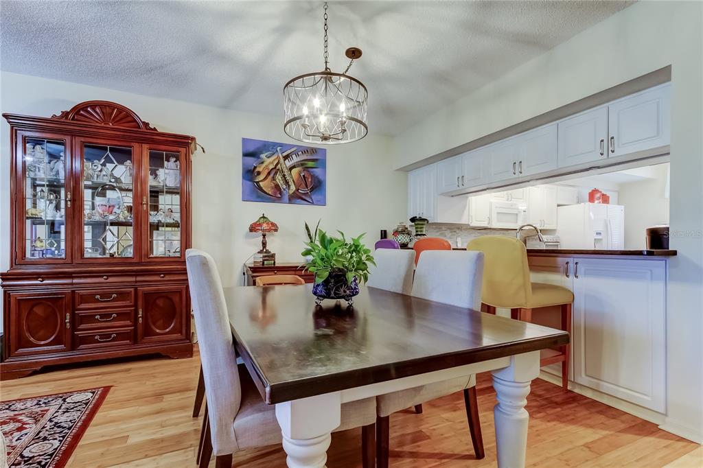 6205 Shoreline Drive, Unit 1304 Seminole, FL 33708 - Photo 19 of 57 a view of a dining room with furniture window and wooden floor