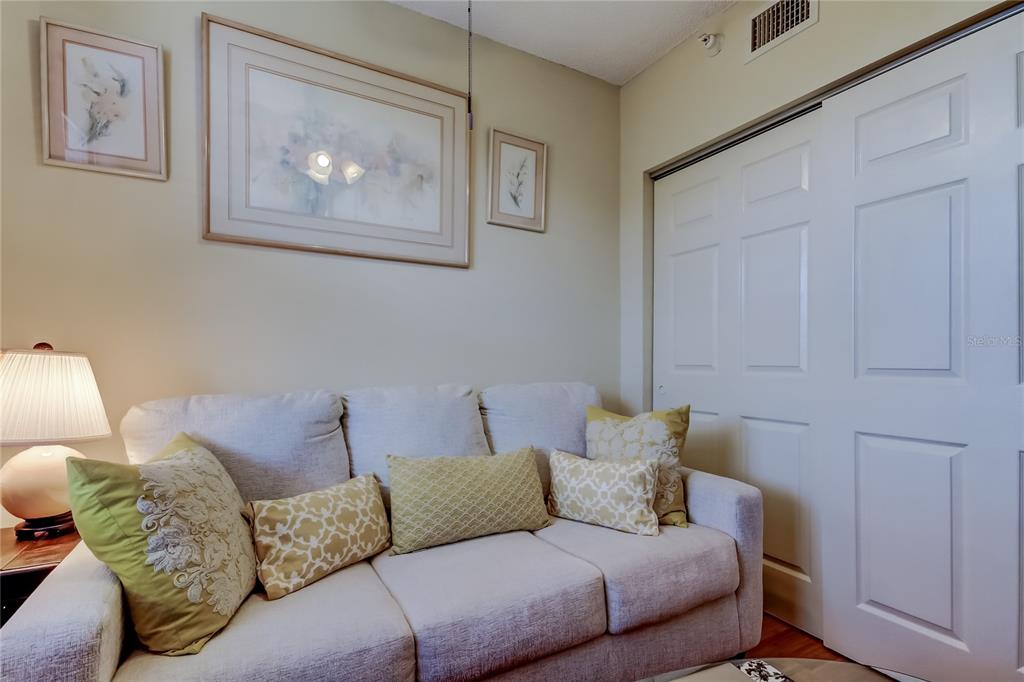 6205 Shoreline Drive, Unit 1304 Seminole, FL 33708 - Photo 22 of 57 a living room with furniture and painting on the wall