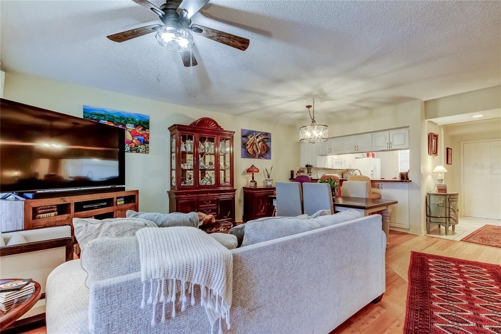 6205 Shoreline Drive, Unit 1304 Seminole, FL 33708 - Photo 24 of 57 a living room with furniture and a flat screen tv