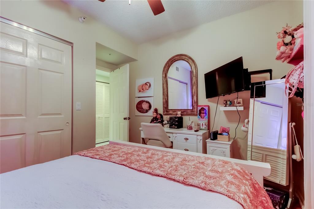 6205 Shoreline Drive, Unit 1304 Seminole, FL 33708 - Photo 29 of 57 a bedroom with a bed and a flat screen tv