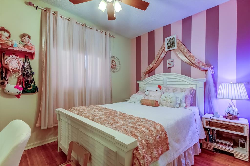 6205 Shoreline Drive, Unit 1304 Seminole, FL 33708 - Photo 30 of 57 a bedroom with a bed and a chandelier