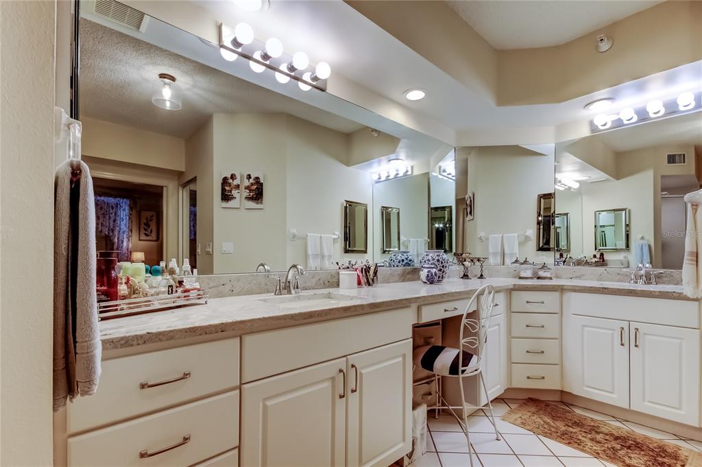 6205 Shoreline Drive, Unit 1304 Seminole, FL 33708 - Photo 43 of 57 a bathroom with a sink vanity and mirror