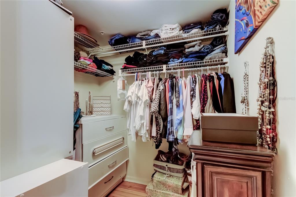 6205 Shoreline Drive, Unit 1304 Seminole, FL 33708 - Photo 45 of 57 a view of walk in closet with clothes and shoes