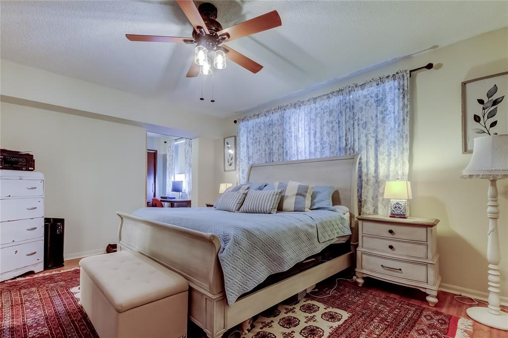 6205 Shoreline Drive, Unit 1304 Seminole, FL 33708 - Photo 46 of 57 a bedroom with a bed and a chandelier