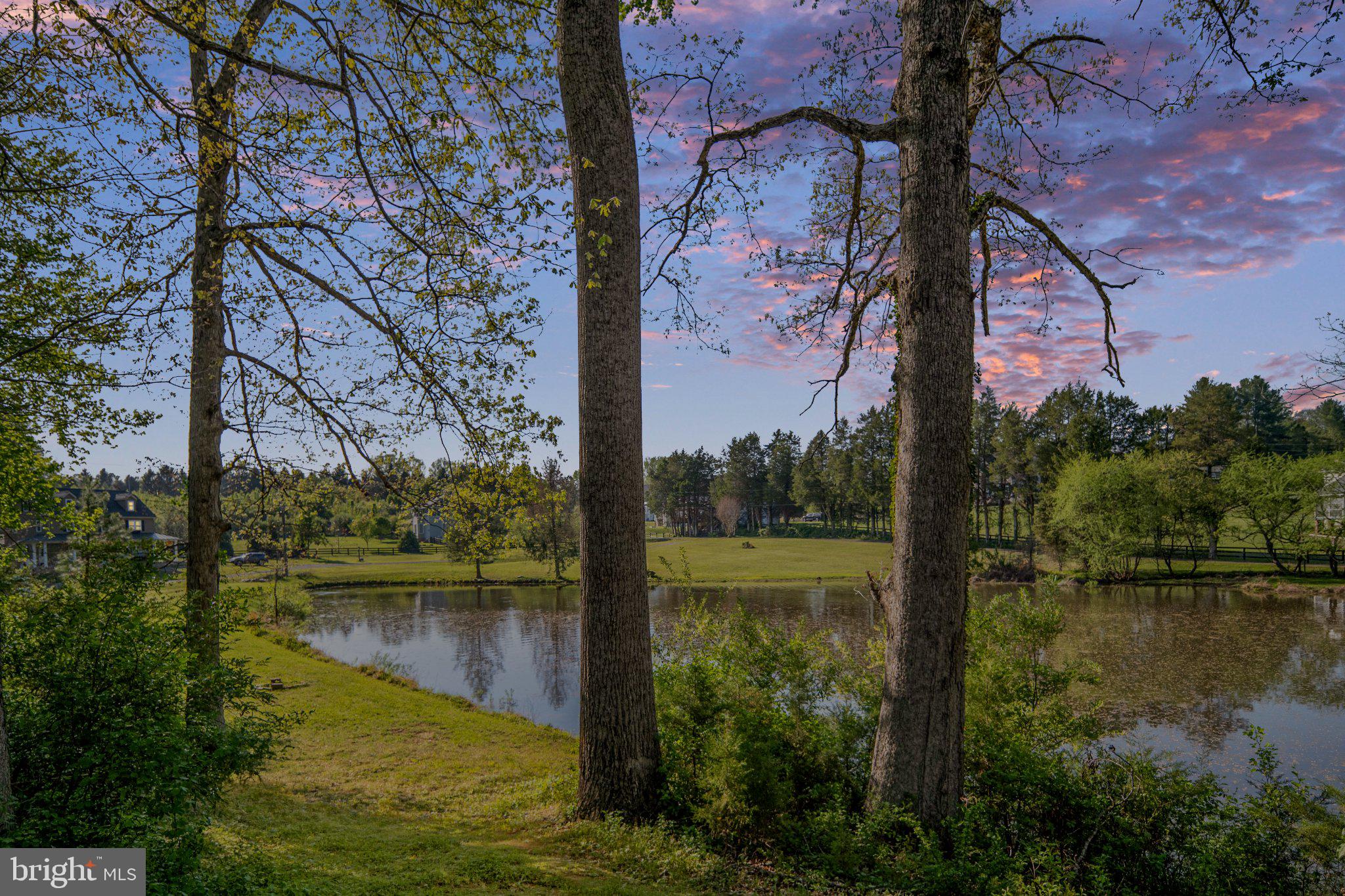 5699 Red Brick Road Warrenton, VA 20187 - Photo 2 of 35 Serene lakeside view at sunset.