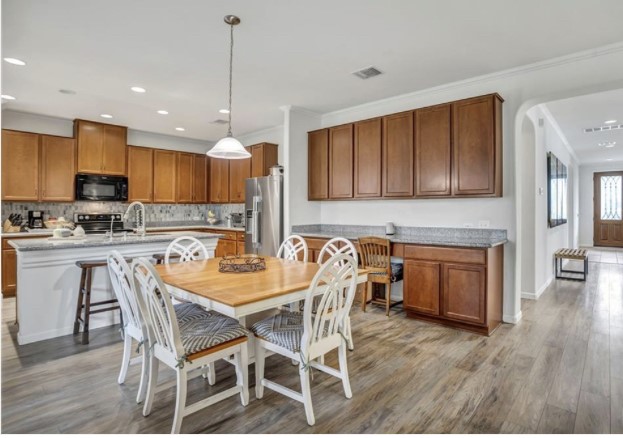 1428 Crested Butte Way Georgetown, TX 78626 - Photo 11 of 28 Dining area with light wood-style flooring, recessed lighting, and arched walkways