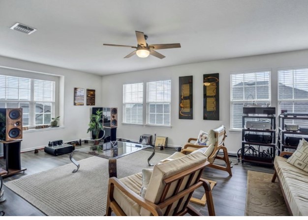 1428 Crested Butte Way Georgetown, TX 78626 - Photo 16 of 28 Living area featuring dark wood-type flooring and a ceiling fan