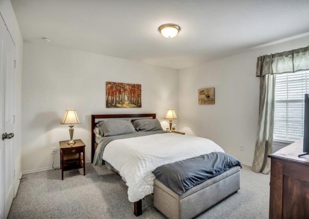 1428 Crested Butte Way Georgetown, TX 78626 - Photo 21 of 28 Bedroom featuring light colored carpet and baseboards