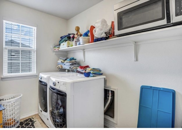 1428 Crested Butte Way Georgetown, TX 78626 - Photo 22 of 28 Laundry area with washer and clothes dryer and baseboards
