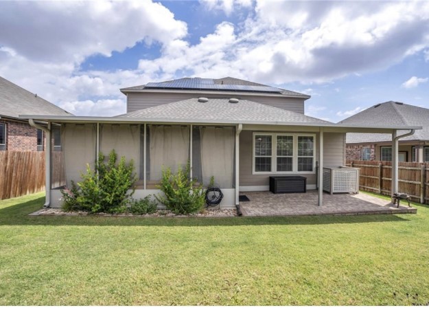 1428 Crested Butte Way Georgetown, TX 78626 - Photo 26 of 28 Back of property with a fenced backyard, solar panels, a shingled roof, and a patio area