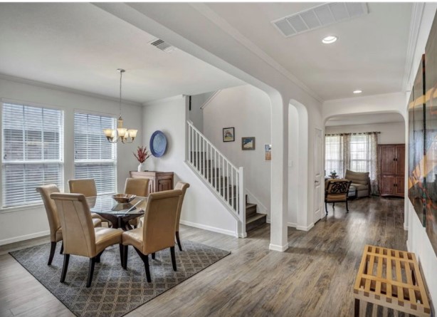 1428 Crested Butte Way Georgetown, TX 78626 - Photo 4 of 28 Dining space featuring stairway, ornamental molding, dark wood-style floors, recessed lighting, and arched walkways