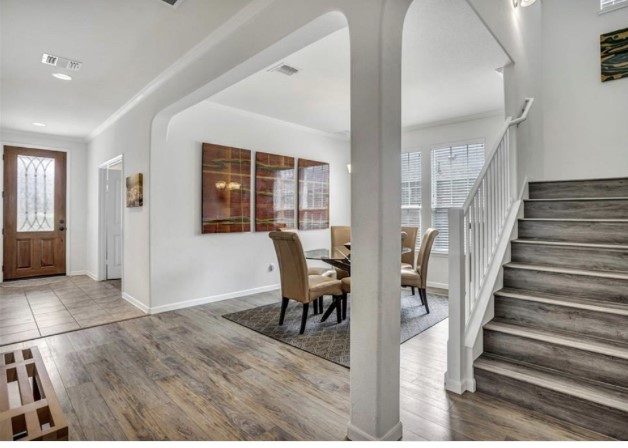 1428 Crested Butte Way Georgetown, TX 78626 - Photo 5 of 28 Foyer entrance featuring wood finished floors, stairs, and ornamental molding