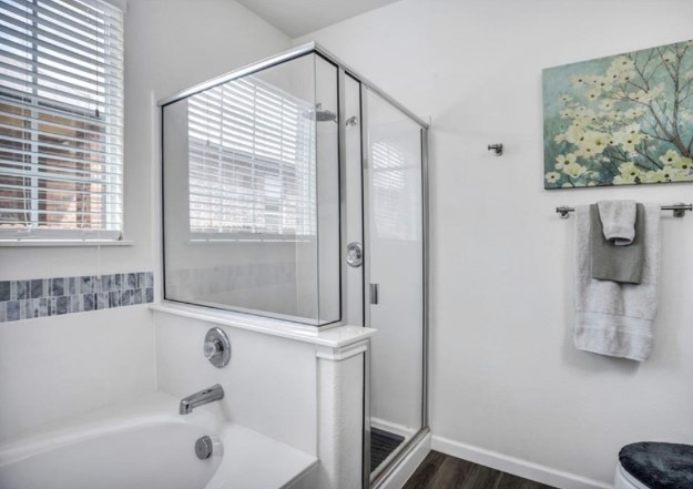 1428 Crested Butte Way Georgetown, TX 78626 - Photo 9 of 28 Bathroom with a bath, a stall shower, and dark wood-type flooring