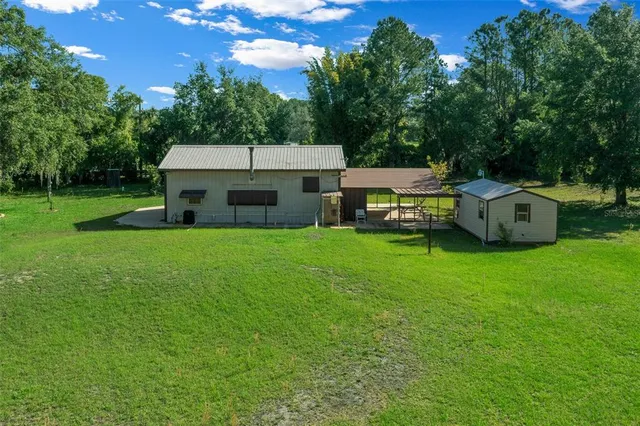 a view of a house with a backyard