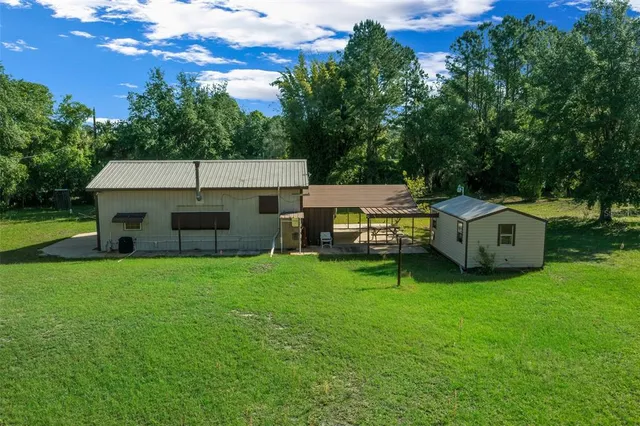 a view of backyard with a garden and entertaining space