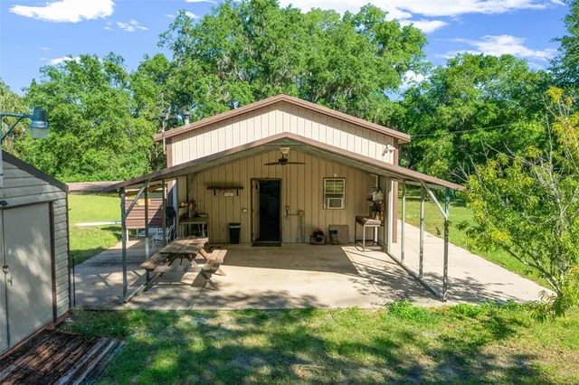 a view of a house with backyard porch and sitting area