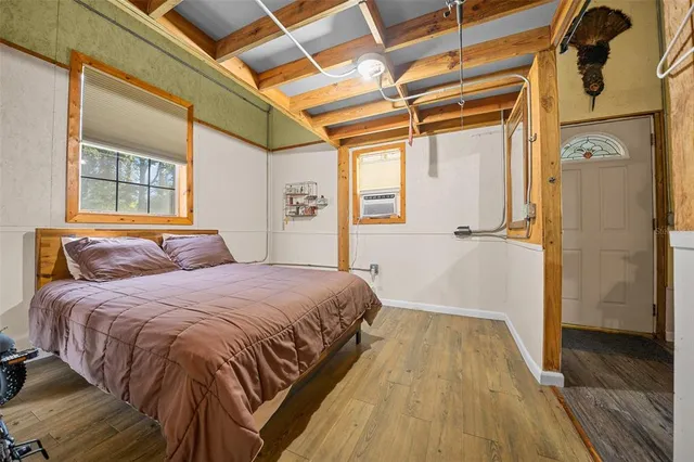 a bedroom with a bed and a window