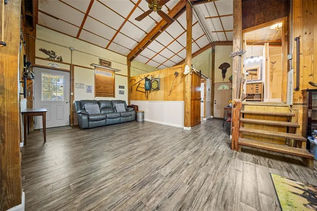 a view of a room with wooden floor and furniture