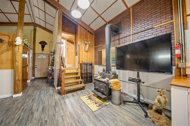 a floor to ceiling room with wooden floor and furniture