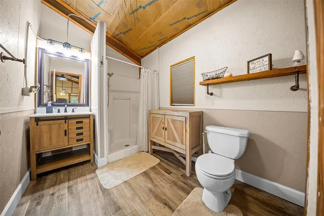 a bathroom with a toilet a sink and a window