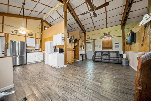 a view of a living room a refrigerator and furniture