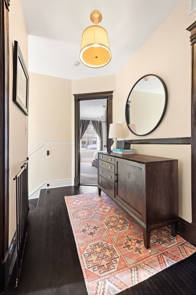 3721 North Racine Avenue Chicago, IL 60613 - Photo 14 of 28 a living room with a bed furniture and a mirror