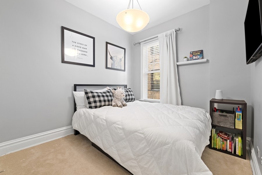 3721 North Racine Avenue Chicago, IL 60613 - Photo 17 of 28 a bedroom with a bed and a tv
