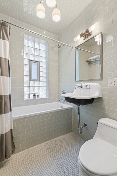 3721 North Racine Avenue Chicago, IL 60613 - Photo 18 of 28 a bathroom with a sink toilet and shower