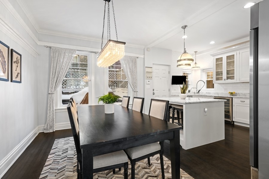 3721 North Racine Avenue Chicago, IL 60613 - Photo 10 of 28 a view of a dining room with furniture and wooden floor