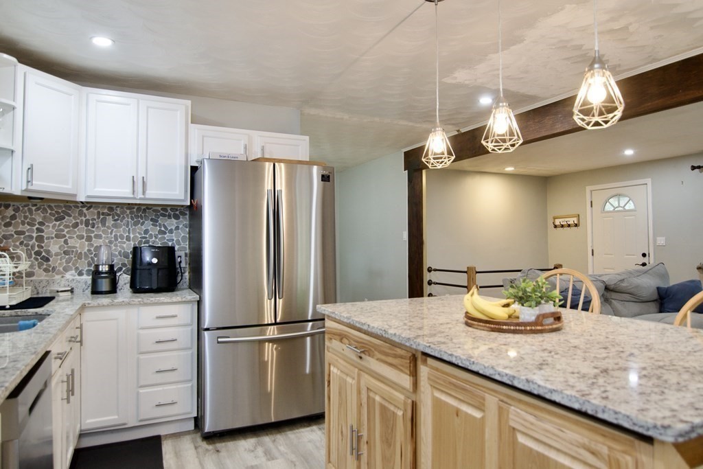 37 Greaney Street Springfield, MA 01104 - Photo 11 of 40 a kitchen with stainless steel appliances granite countertop a refrigerator a sink and a stove