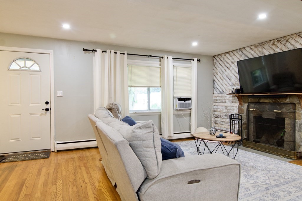 37 Greaney Street Springfield, MA 01104 - Photo 19 of 40 a living room with furniture a fireplace and a flat screen tv