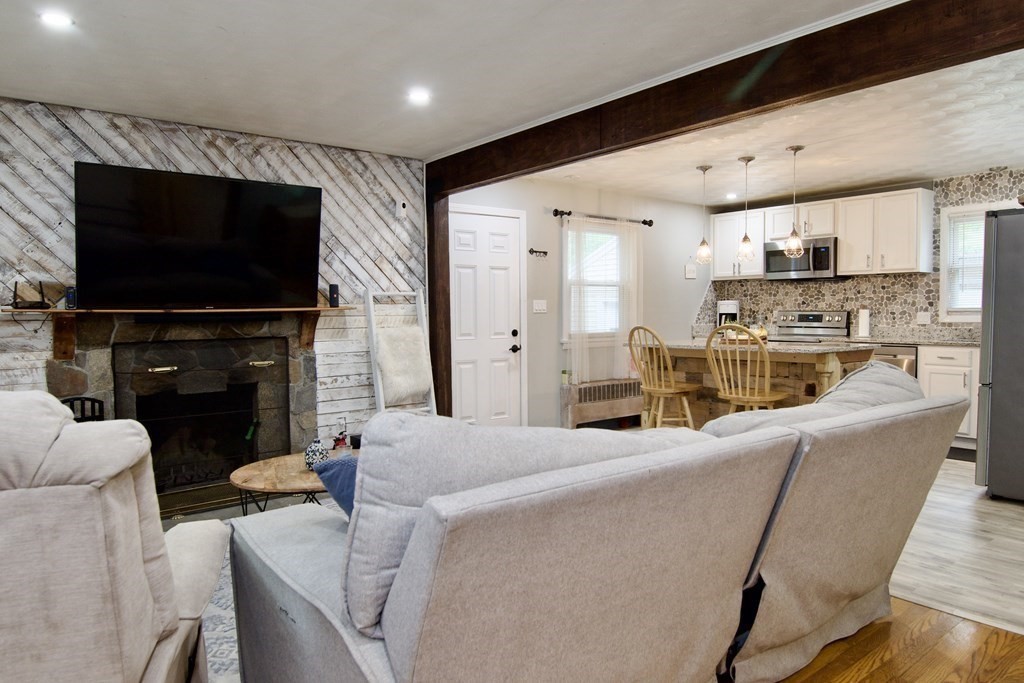 37 Greaney Street Springfield, MA 01104 - Photo 22 of 40 a living room with fireplace furniture and a flat screen tv