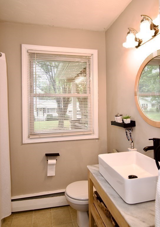 37 Greaney Street Springfield, MA 01104 - Photo 30 of 40 a bathroom with a sink a toilet and a mirror