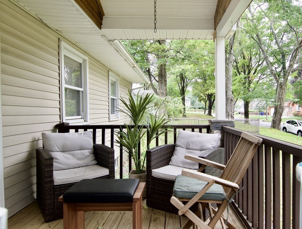 37 Greaney Street Springfield, MA 01104 - Photo 3 of 40 a view of a patio with table and chairs potted plants and large tree