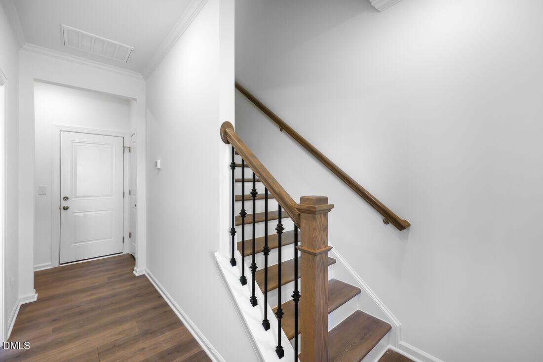 430 Rowe Way Knightdale, NC 27545 - Photo 15 of 51 a view of staircase with wooden floor and white walls